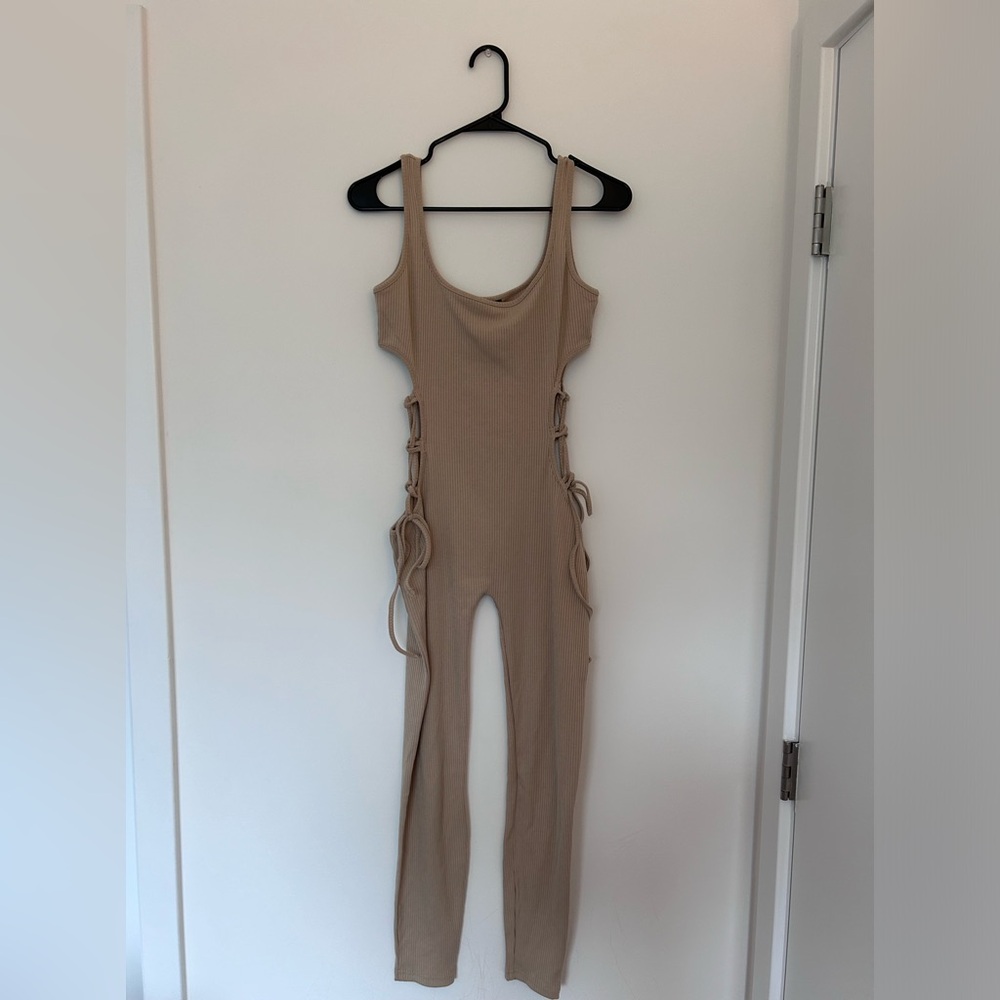 Tan jumpsuit that ties up on the sides